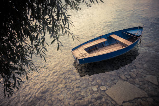 High angle image of a empty wooden boat floating on water.
