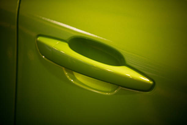istock Modern door handle of a green car 1358635510