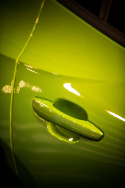 istock Modern door handle of a green car 1358635513