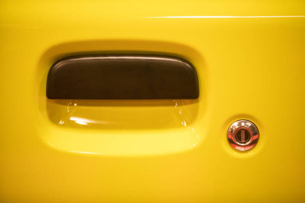 istock Modern door handle of a yellow car 1358635523