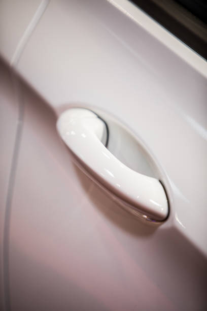istock Modern door handle of a white car 1358635625