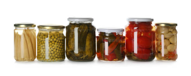 istock Glass jars with different pickled vegetables and mushrooms on white background 1358636525