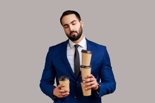istock Businessman coffee cups and sleeping, feeling exhausted bored after stressful working day. 1358638046