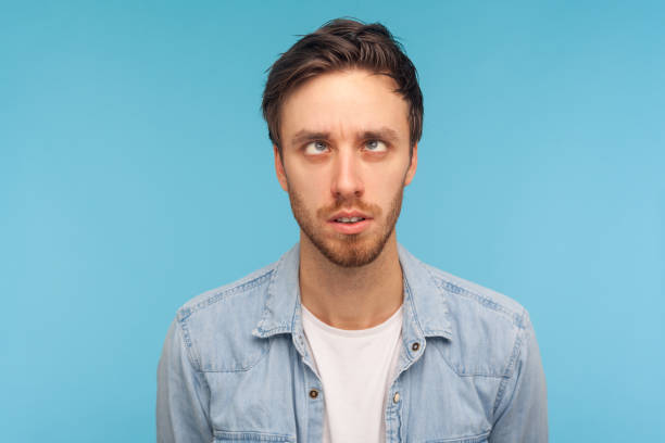 istock Comic positive man looking cross-eyed, having fun with silly face expression, playing fool. 1358639100
