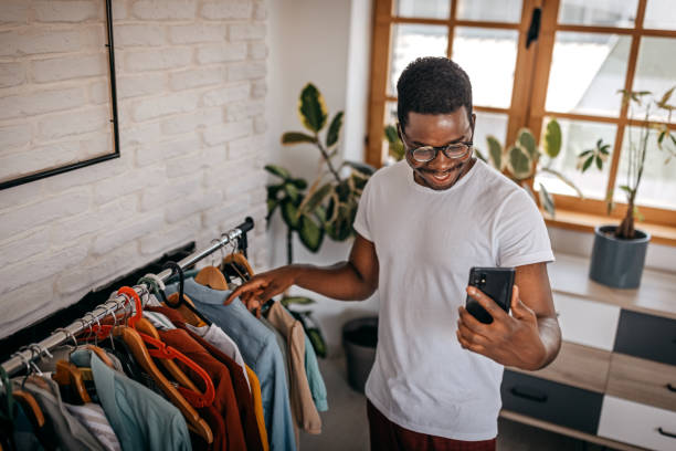 istock Man recording blog while showing clothes as influencer 1358639294