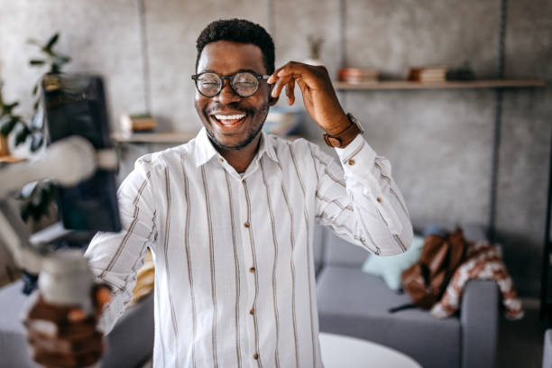 istock Cheerful young man excited recording vlog at home 1358640155