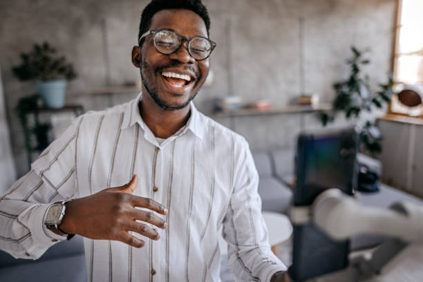 istock Laughing young man recording vlog at home 1358640230