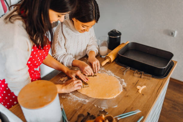 istock Mom and daughter baking cakes in her kitchen 1358641672