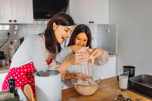 istock Mom and daughter baking cakes in her kitchen 1358641744