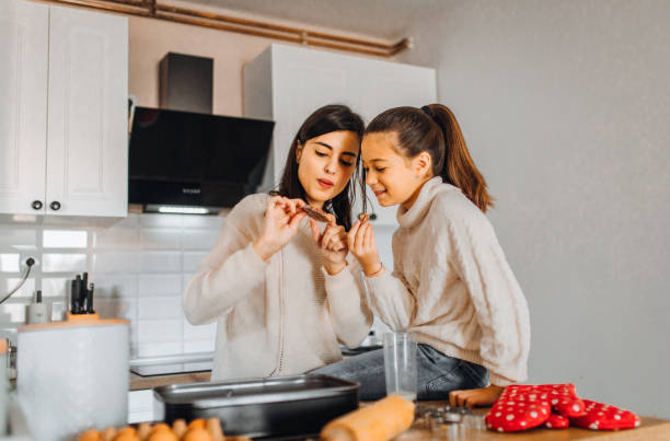 istock Mom and daughter baking cakes in her kitchen 1358641823