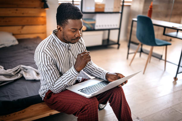 istock Thoughtful man working on laptop at home 1358643710