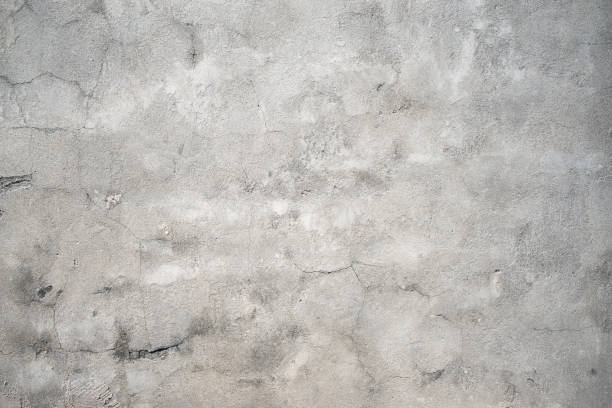 istock Dark gray stucco cracked spotted wall texture background 1358644505