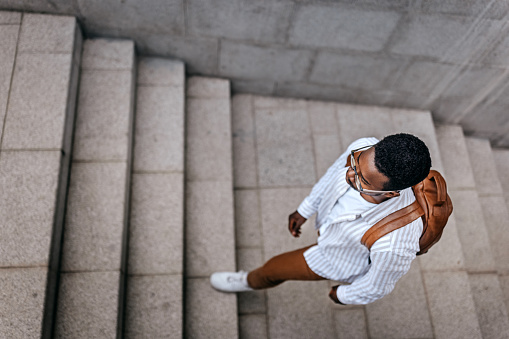 Woman in sportswear climbs up stairs closeup. Walking and fitness concept