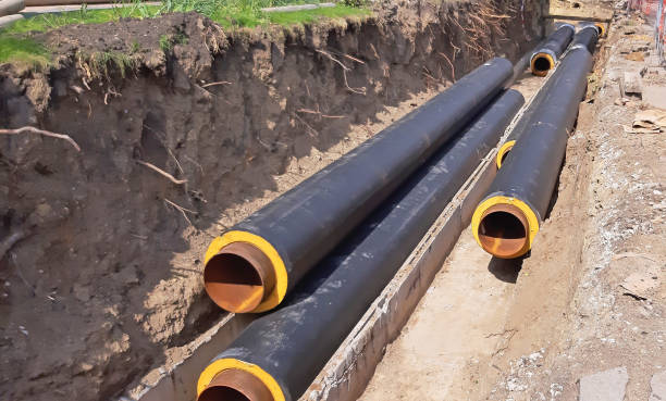 istock Some central heating pipes next to a ditch - in the process of connecting - instaling 1358649057
