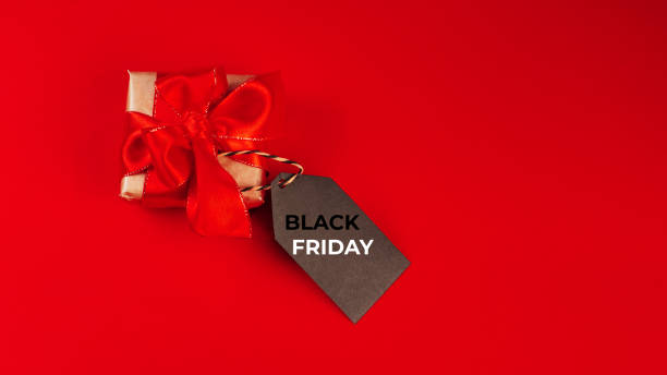 istock Gift box on a red background.Minimalism style. Creative design. Copy space. Banner.Sale, discount, shopaholism concept. Consumer society trend.Black Friday Super Sale.Black Friday shopping sale concept with red ticket Sale tag close up. 1358653669