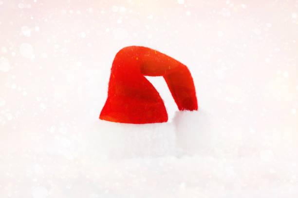 istock Hat Santa Claus Snow Light Background Celebratory Background New Year concept. Copy space. Christmas card.Simple minimalistic.Christmas home decor. 1358654266