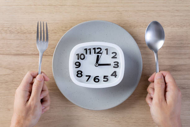 istock Eat meal time healthy eating concept hand hold spoon and fork 1358655556