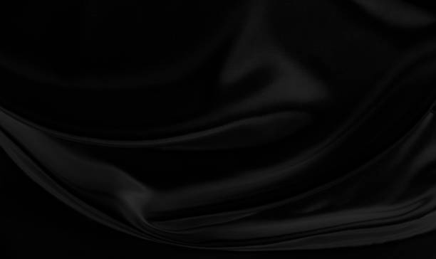 istock Black gray satin dark fabric texture luxurious shiny that is abstract silk cloth background with patterns soft waves blur beautiful. 1358663990