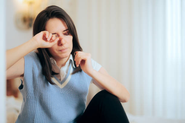 istock Depressed Woman Holding Wedding Ring Crying after Divorce 1358664077