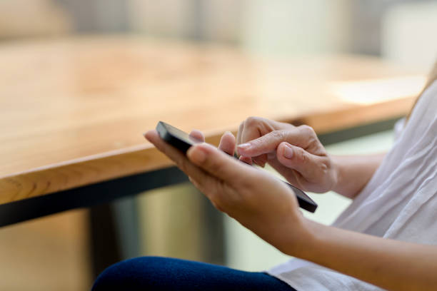 istock Close up. Woman hand using smartphone order goods online. 1358665791