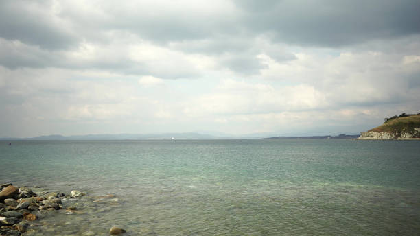 istock Seascape with rocky beach and clear sea 1358667489