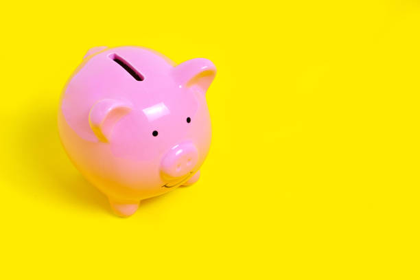 istock Pink Piggy Bank on Yellow Background 1358670169
