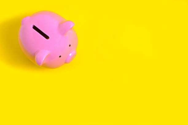 istock Pink Piggy Bank on Yellow Background 1358670170