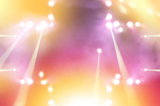 blurred empty theater stage with fun colourful spotlights, abstract image of concert lighting illumination background