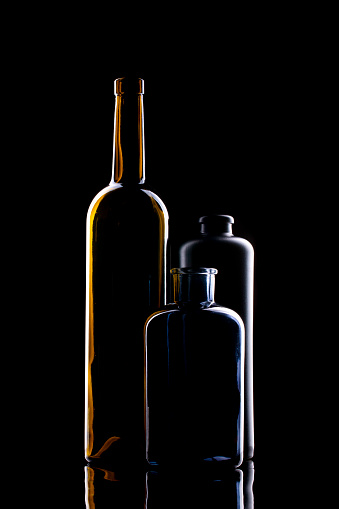 Still life with glass objects on a black background