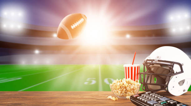 Food and drinks on a wooden table . TV broadcast of American football background. Sport bar concept Food and drinks on a wooden table . TV broadcast of American football background. Sport bar concept football field night american culture empty stock pictures, royalty-free photos & images