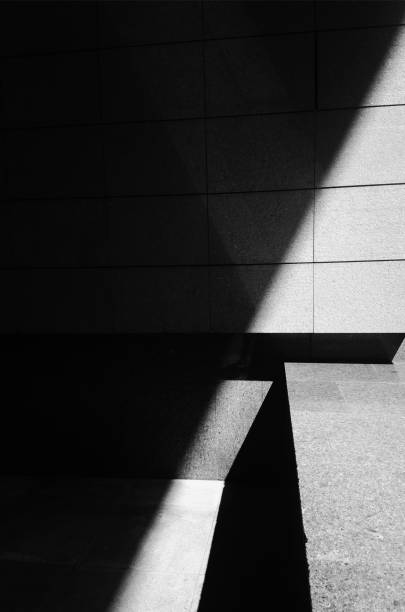 istock Diagonal sun rays illuminating simple architecture 1358688626