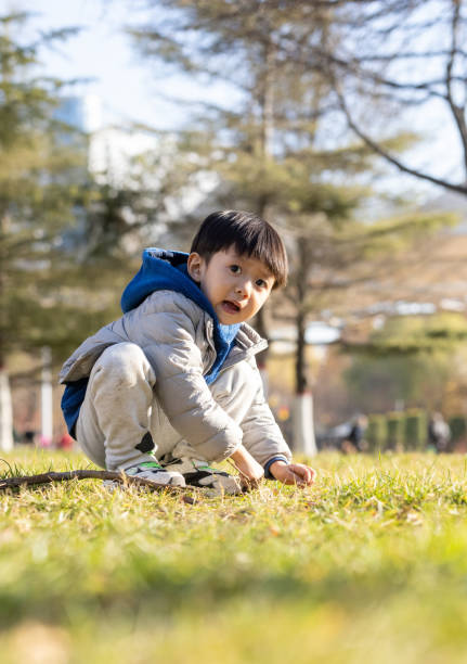 istock The little boy is playing on the grass 1358691706