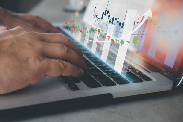 istock Man uses computer analyzes data for forex trading. Stock market investments funds and digital assets. 1358693018