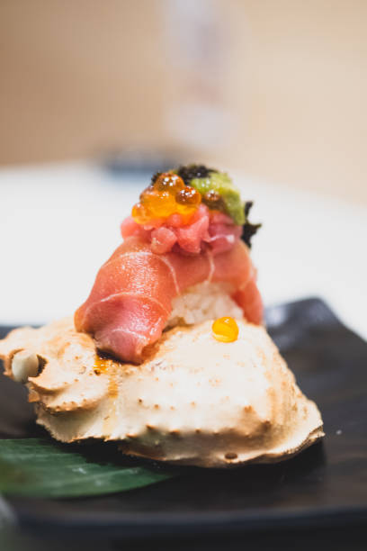 istock Tuna sushi with roe on top served on crab carapace 1358694454
