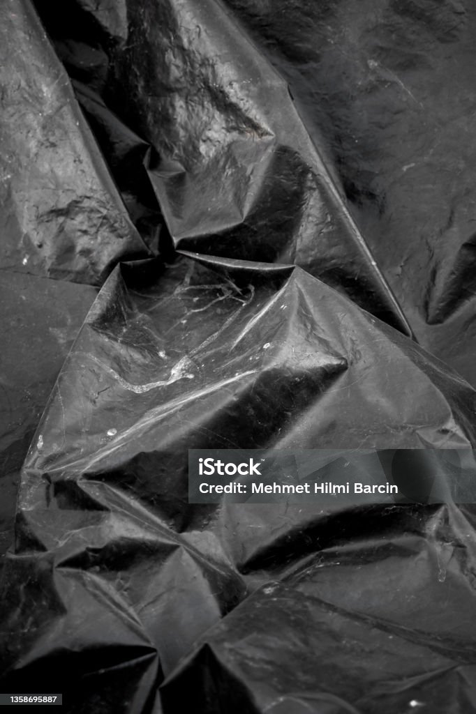 Crumpled Black Plastic Bag texture background Black sachet Textured Stock Photo