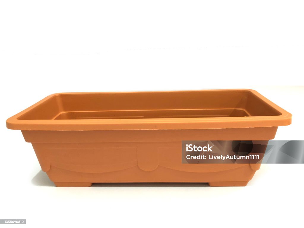 brown plastic rectangular garden pot, gardening planting flower pot A brown gardening pot made of plastic. Flower Pot Stock Photo