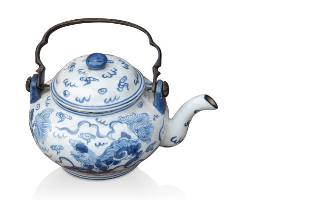 istock side view antique white and blue ceramic teapot on black background, object background,  vintage, retro, copy space 1358698594