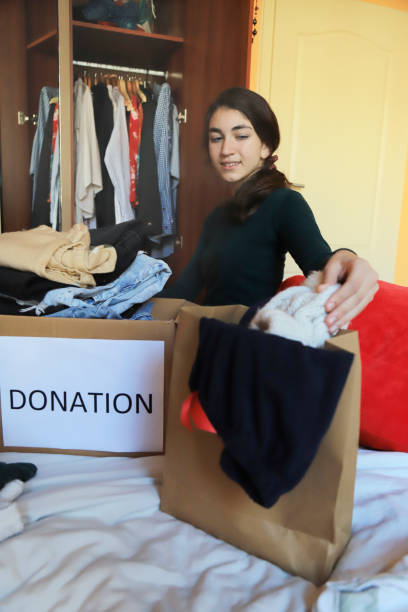 istock Girl donating clothes 1358699457