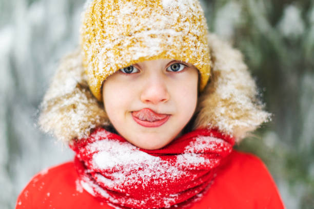 istock Little boy having fun in winter forest 1358700899