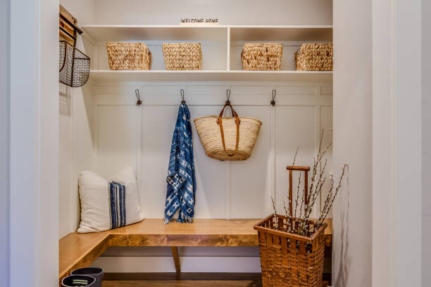 Cozy mudroom nook Natural wood bench and cubbies with baskets is a designer's dream coat rack stock pictures, royalty-free photos & images