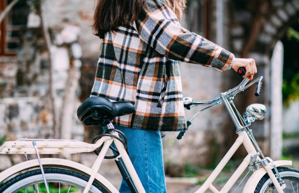 istock Young Woman Riding a Bike 1358704396