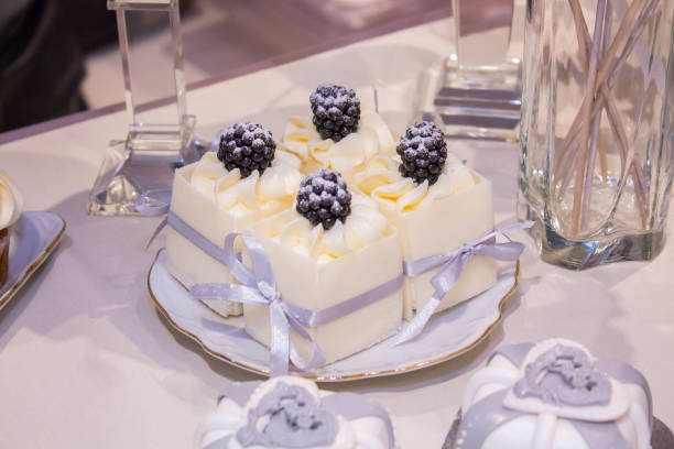 istock White wedding cakes with a lilac ribbon. 1358705073