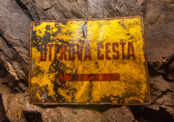 istock Old rusty sign in the mine showing the escape route to the emergency exit 1358705099