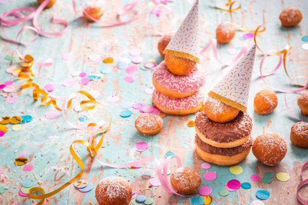 istock Krapfen, Berliner and donuts with streamers and confetti 1358705165