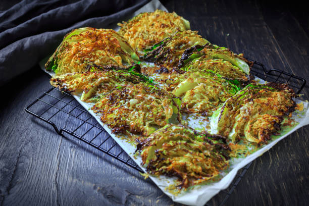 Baked savoy cabbage with parmesan cheese, honey and spices on baking sheet