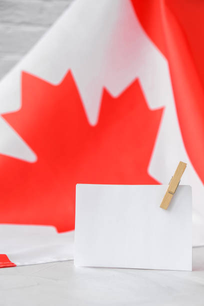 istock The National Flag of Canada. Canadian Flag or the Maple Leaf with empty paper note Copy space. Tourist traveler or patriotism. International relations concept. Independence day 1358705424