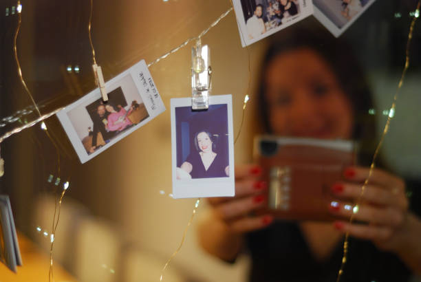 istock Happy woman taking selfie with polaroid camera. 1358706475