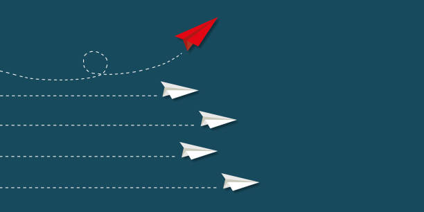 istock Red paper plane change direction from group on blue background as metaphor for business creativity new idea. 1358707435