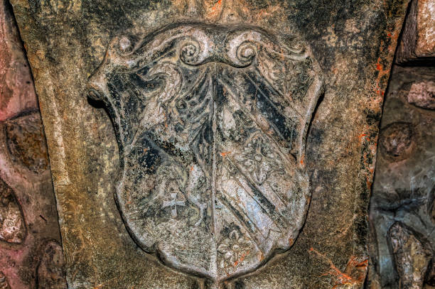 A weathered Lion Rampart coat of arms, located at the base of the 19th Century statue of Robert the Bruce in the town of Stirling, Scotland.
