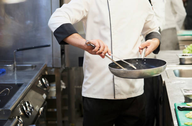 istock Chef cooking food in restaurant kitchen, close-up 1358713860